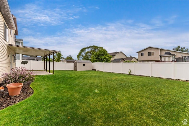 view of yard featuring a shed, a patio area, and an outdoor structure