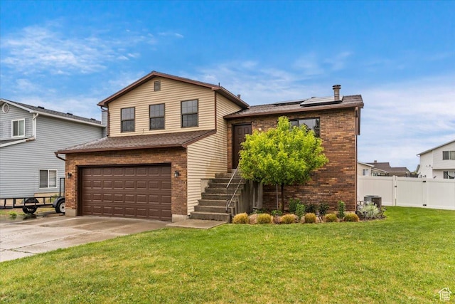 split level home featuring brick siding, an attached garage, roof mounted solar panels, concrete driveway, and stairs