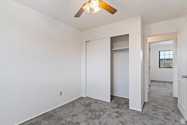 unfurnished bedroom with carpet flooring, a closet, baseboards, and ceiling fan