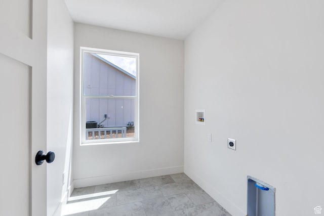 washroom with electric dryer hookup, hookup for a washing machine, baseboards, and marble look tiles