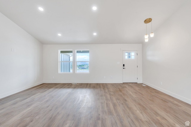 foyer entrance with baseboards, light wood-style flooring, and recessed lighting