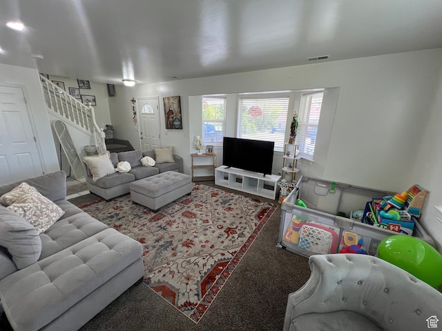 living room featuring stairs