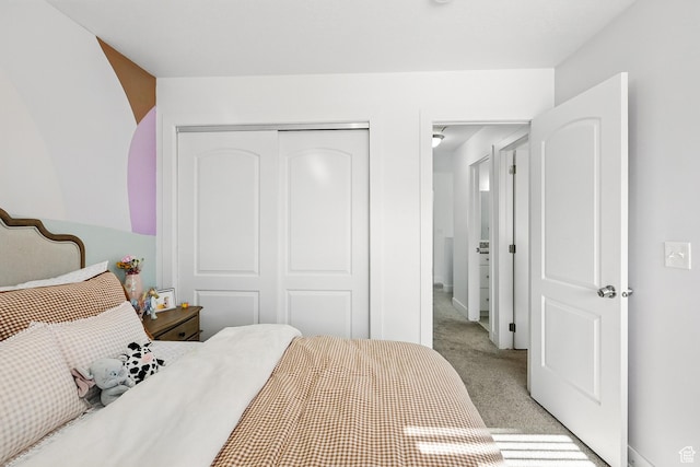 bedroom with light colored carpet and a closet