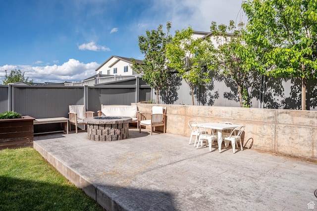 view of patio with a fire pit and fence
