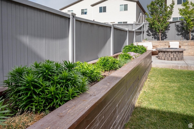 view of yard with a fire pit and fence