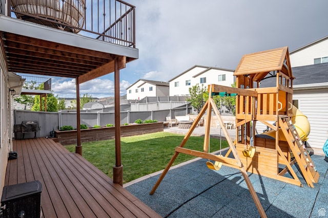 view of playground with a residential view and a wooden deck
