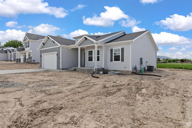 676 E 2450 N, North Logan, UT 84341 - view of front facade featuring a garage, driveway, board and batten siding, and a shingled roof