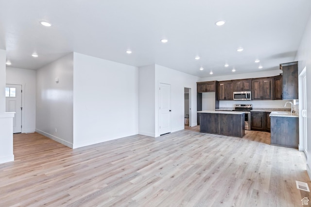 676 E 2450 N, North Logan, UT 84341 - kitchen featuring stainless steel appliances, a sink, dark brown cabinetry, light countertops, and recessed lighting