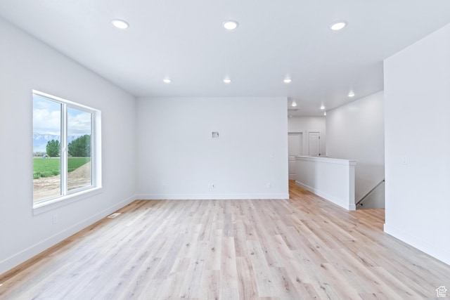 676 E 2450 N, North Logan, UT 84341 - unfurnished living room with recessed lighting, light wood-type flooring, and baseboards