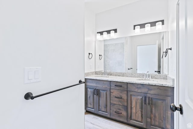 676 E 2450 N, North Logan, UT 84341 - bathroom featuring double vanity and wood finished floors
