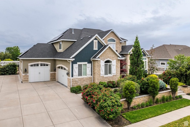 1309 W Atrium Ct W, Farmington, UT 84025 - craftsman house featuring stone siding, a garage, roof with shingles, and concrete driveway