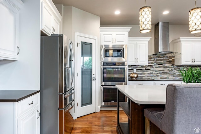 1309 W Atrium Ct W, Farmington, UT 84025 - kitchen featuring stainless steel appliances, wall chimney exhaust hood, backsplash, and white cabinetry