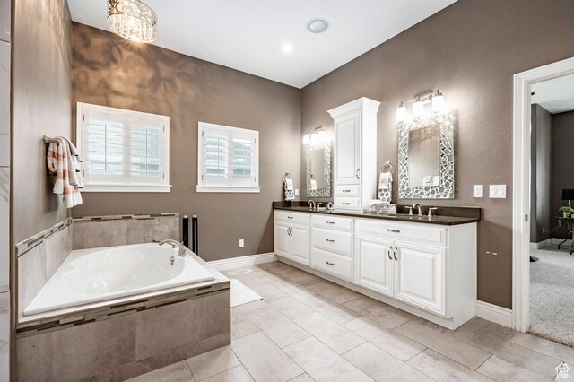 1309 W Atrium Ct W, Farmington, UT 84025 - bathroom with a garden tub, double vanity, and baseboards