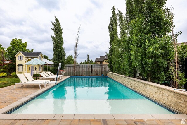 1309 W Atrium Ct W, Farmington, UT 84025 - view of swimming pool with a patio area, fence, an outdoor structure, and an exterior structure