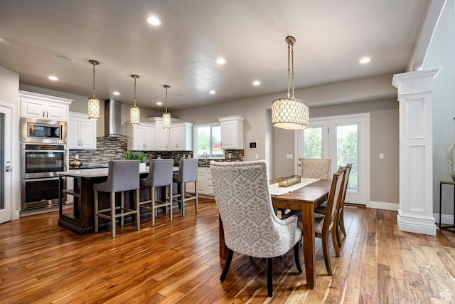 1309 W Atrium Ct W, Farmington, UT 84025 - dining space with hardwood / wood-style flooring, recessed lighting, ornate columns, and baseboards