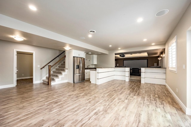 1309 W Atrium Ct W, Farmington, UT 84025 - unfurnished living room featuring light wood-style flooring, stairs, baseboards, and recessed lighting