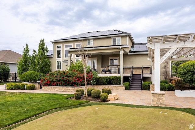 1309 W Atrium Ct W, Farmington, UT 84025 - view of front of home featuring stucco siding, a putting green, solar panels, a pergola, and stairs