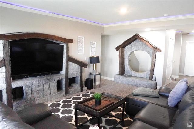 68 Hawksbeard Cir, Fish Haven, ID 83287 - carpeted living area with ornamental molding, baseboards, and a fireplace