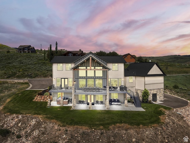 68 Hawksbeard Cir, Fish Haven, ID 83287 - back of house with a patio area, stairs, stone siding, and a lawn