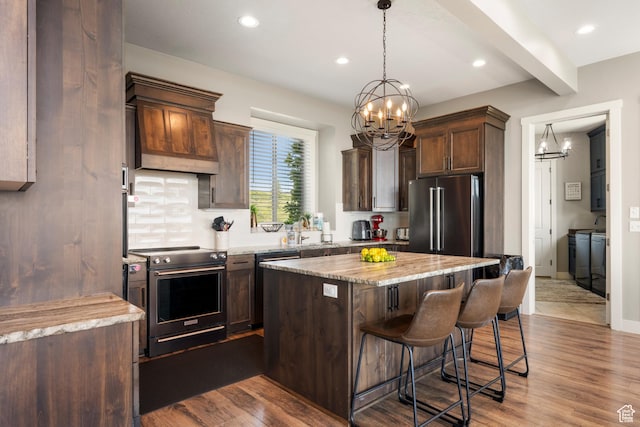 68 Hawksbeard Cir, Fish Haven, ID 83287 - kitchen with stainless steel appliances, a chandelier, a kitchen island, a breakfast bar area, and recessed lighting