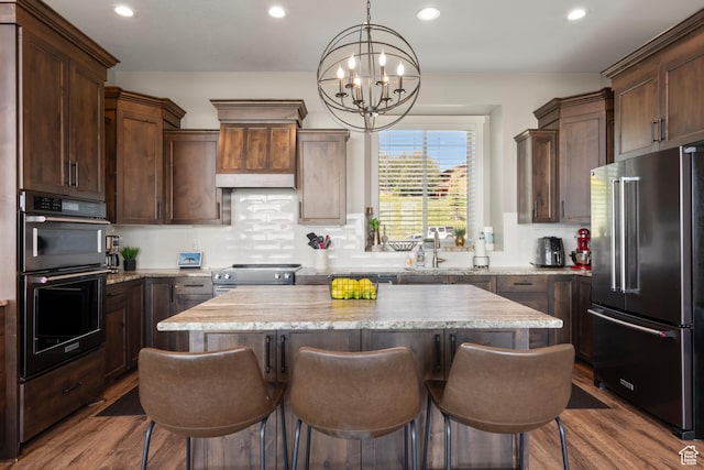 68 Hawksbeard Cir, Fish Haven, ID 83287 - kitchen featuring appliances with stainless steel finishes, a chandelier, a kitchen bar, a center island, and recessed lighting