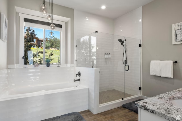 68 Hawksbeard Cir, Fish Haven, ID 83287 - bathroom featuring a garden tub, vanity, a shower stall, and wood finished floors
