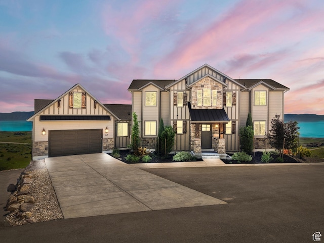 68 Hawksbeard Cir, Fish Haven, ID 83287 - view of front of home with stone siding, board and batten siding, concrete driveway, a garage, and a standing seam roof