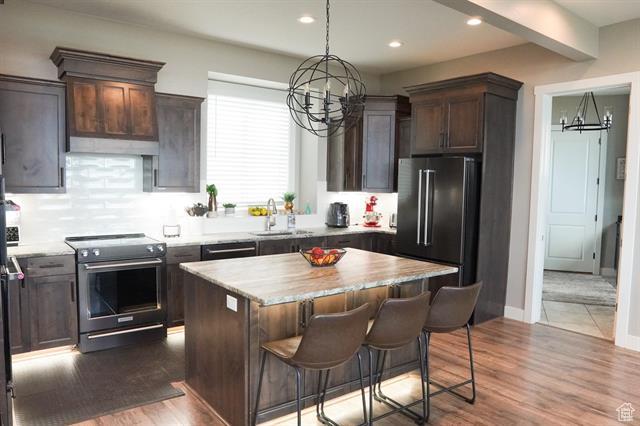 68 Hawksbeard Cir, Fish Haven, ID 83287 - kitchen featuring stainless steel electric stove, a sink, a chandelier, dark brown cabinets, and recessed lighting