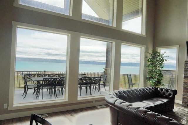68 Hawksbeard Cir, Fish Haven, ID 83287 - living room featuring a water view, a high ceiling, and wood finished floors