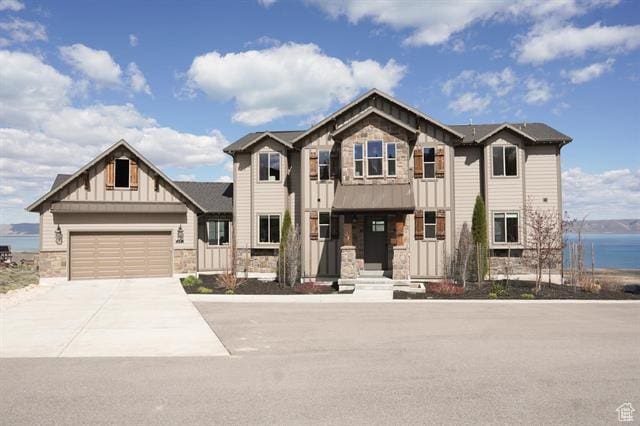 68 Hawksbeard Cir, Fish Haven, ID 83287 - view of front of house featuring stone siding, board and batten siding, driveway, and an attached garage