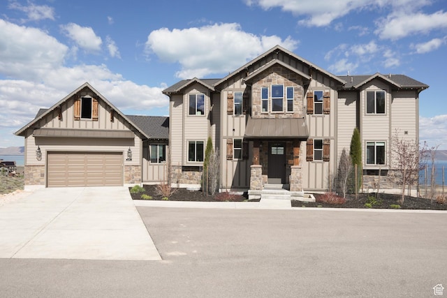 68 Hawksbeard Cir, Fish Haven, ID 83287 - craftsman house with stone siding, board and batten siding, concrete driveway, a standing seam roof, and an attached garage