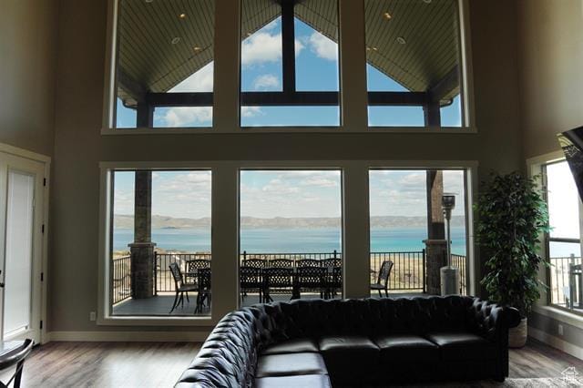 68 Hawksbeard Cir, Fish Haven, ID 83287 - living room with a water view, wood finished floors, baseboards, and a towering ceiling