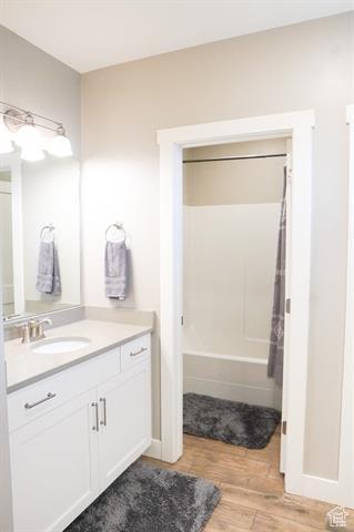 68 Hawksbeard Cir, Fish Haven, ID 83287 - full bathroom featuring wood finished floors, vanity, shower / bath combination with curtain, and baseboards