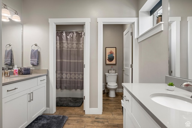 68 Hawksbeard Cir, Fish Haven, ID 83287 - full bathroom featuring wood finished floors, two vanities, and curtained shower