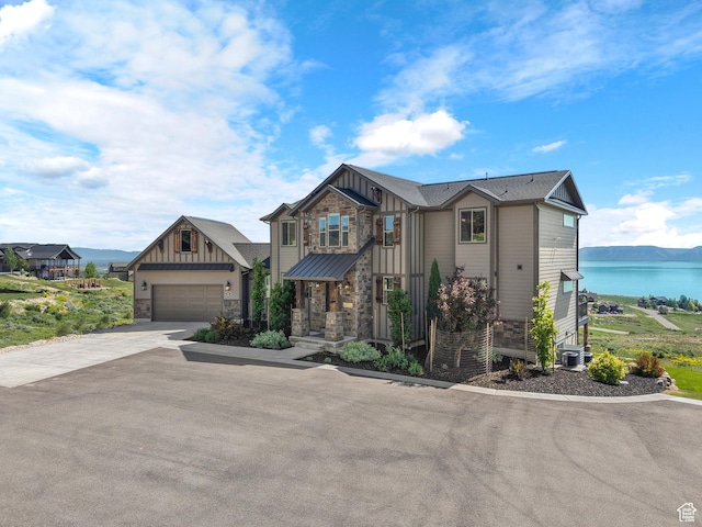 68 Hawksbeard Cir, Fish Haven, ID 83287 - view of front facade featuring board and batten siding, stone siding, and driveway