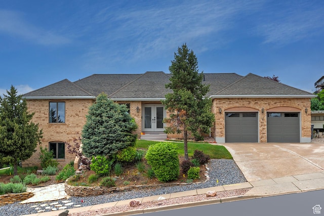 193 Coventry Ln, North Salt Lake, UT 84054 - view of front facade with brick siding, french doors, a garage, and driveway