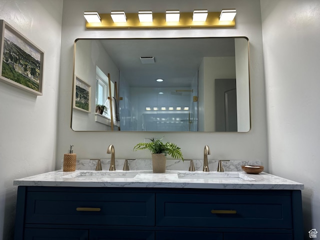 full bath featuring double vanity and a shower
