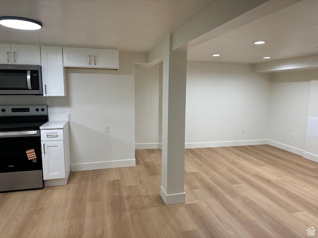 kitchen featuring stainless steel appliances, white cabinets, light wood-type flooring, baseboards, and recessed lighting