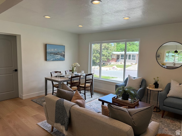 living room with baseboards, light wood-style floors, and recessed lighting