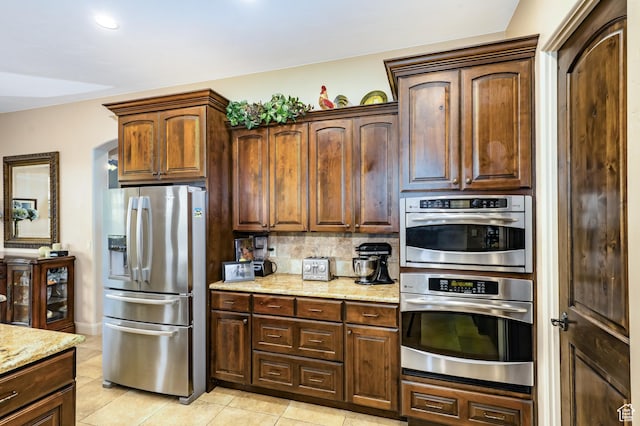 373 W Meridian Dr, Ivins, UT 84738 - kitchen featuring stainless steel appliances, light tile patterned flooring, light stone countertops, and tasteful backsplash
