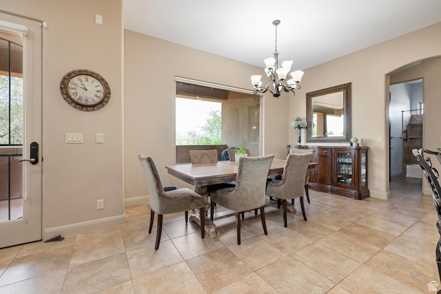 373 W Meridian Dr, Ivins, UT 84738 - dining area featuring a chandelier, arched walkways, and light tile patterned floors