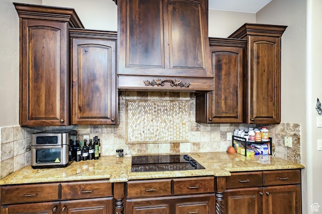 373 W Meridian Dr, Ivins, UT 84738 - kitchen with black electric stovetop, tasteful backsplash, light stone countertops, and dark brown cabinetry