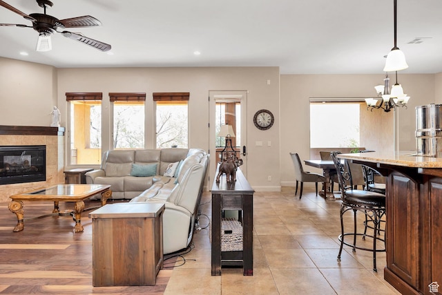 373 W Meridian Dr, Ivins, UT 84738 - living area with plenty of natural light, recessed lighting, a ceiling fan, a tiled fireplace, and a chandelier