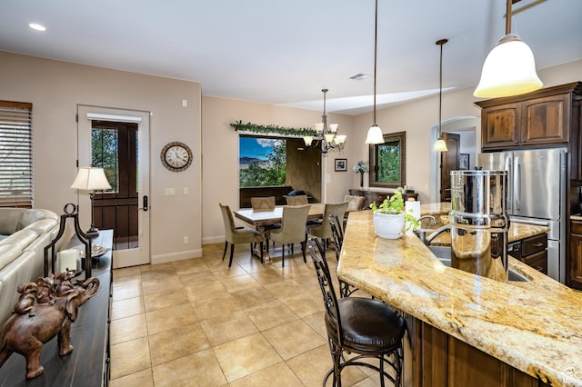 373 W Meridian Dr, Ivins, UT 84738 - kitchen with light stone countertops, freestanding refrigerator, a chandelier, healthy amount of natural light, and recessed lighting