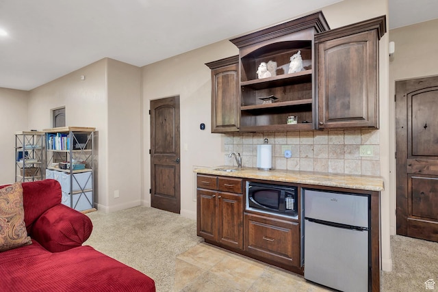 373 W Meridian Dr, Ivins, UT 84738 - kitchen with freestanding refrigerator, black microwave, open shelves, light carpet, and dark brown cabinets