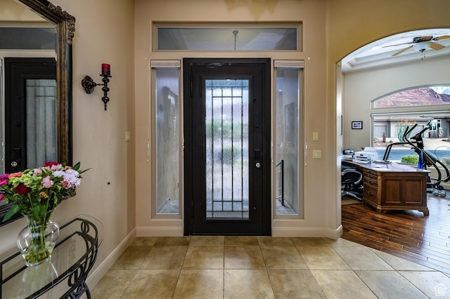 373 W Meridian Dr, Ivins, UT 84738 - entryway with baseboards, ceiling fan, arched walkways, and light tile patterned flooring