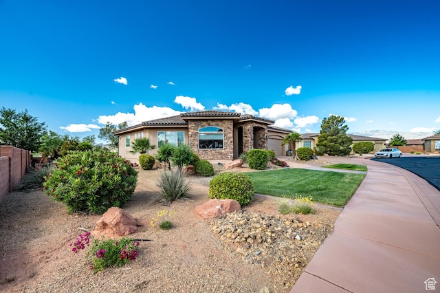373 W Meridian Dr, Ivins, UT 84738 - mediterranean / spanish house featuring stone siding, a tile roof, a garage, stucco siding, and driveway