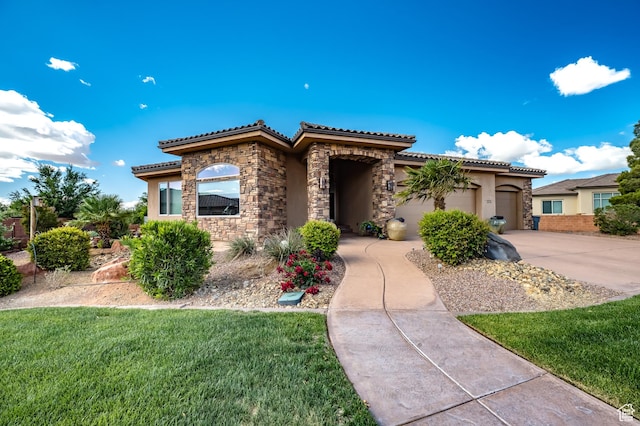 373 W Meridian Dr, Ivins, UT 84738 - mediterranean / spanish house with stone siding, a tile roof, stucco siding, and concrete driveway
