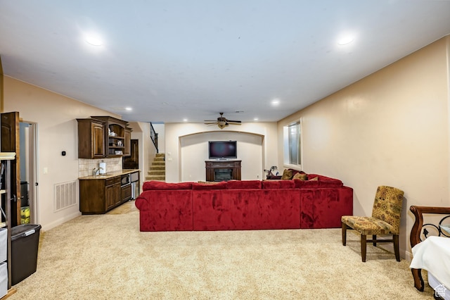 373 W Meridian Dr, Ivins, UT 84738 - living room featuring light colored carpet, stairs, a fireplace, a ceiling fan, and recessed lighting