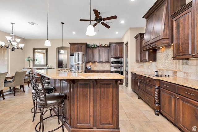 373 W Meridian Dr, Ivins, UT 84738 - kitchen with black electric stovetop, backsplash, a ceiling fan, light stone counters, and dark brown cabinets
